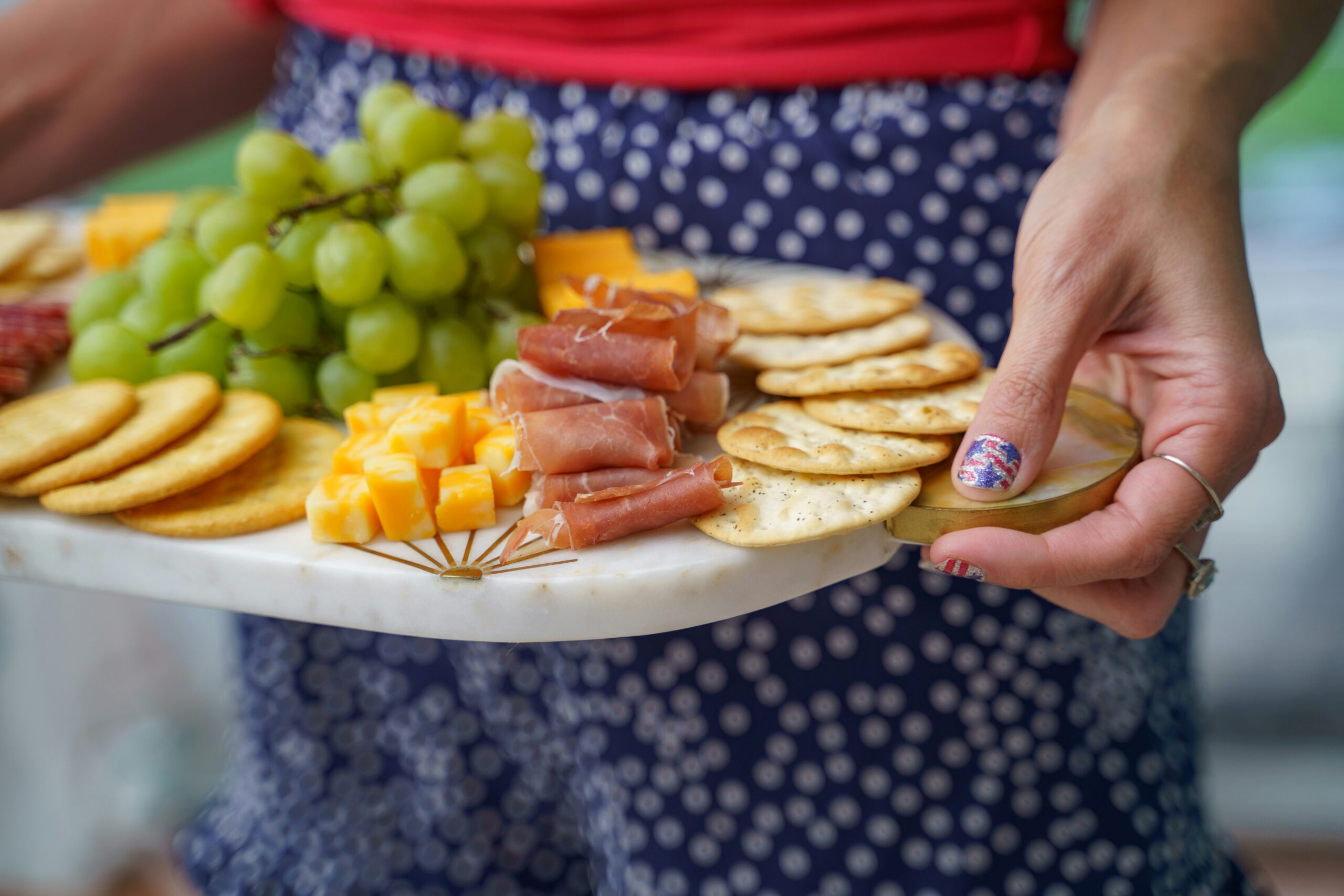 A simple, cozy lunch plate with crackers, fruit, cheese, and easy mom‑friendly foods on a soft, neutral background.